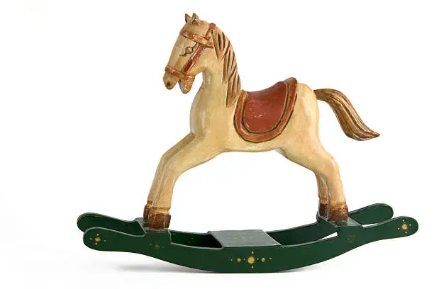 Handpainted miniature rocking horse, distressed paint finish, isolated on white.