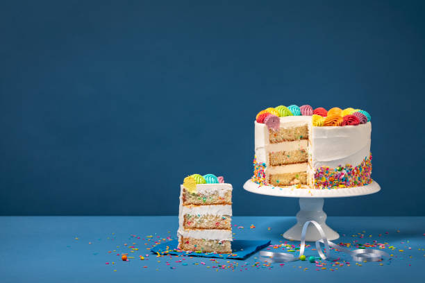 istock Colorful Birthday Cake with Slice and Sprinkles 1158949477