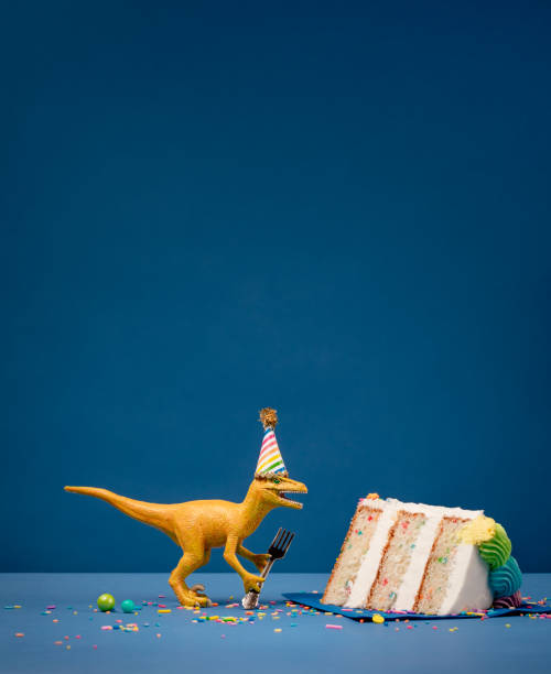 istock Dinosaur and slice of Birthday Cake 1158950015