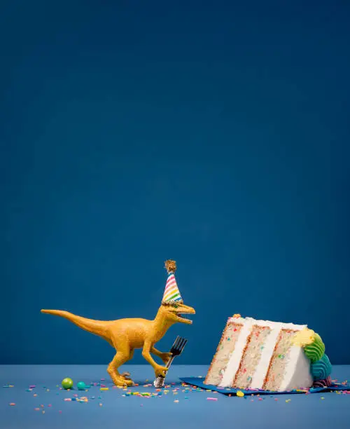 Photo of Dinosaur and slice of Birthday Cake