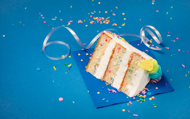 istock Slice of Birthday Cake on blue 1158950027