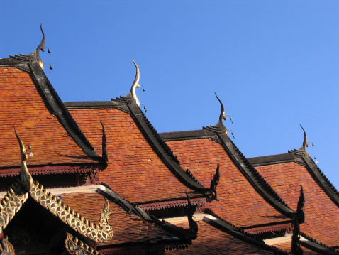 Tiled rooftops of a Buddhist monastery in Chiang Mai, Thailand.