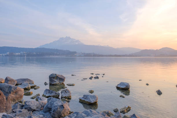 Beautiful light evening on the rock near the lake on mountain background in Lucerne town Switzerland.