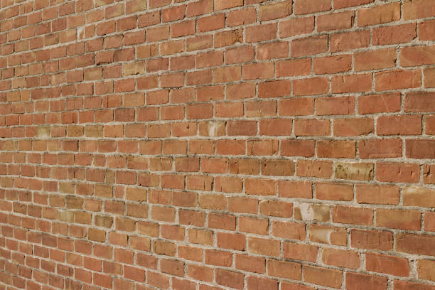 istock Antique reddish brown brick wall background in traditional running bond pattern (angle view) 1158958709