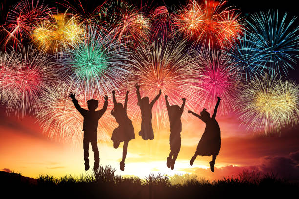 istock happy children jumping and watching the fireworks 1158958713