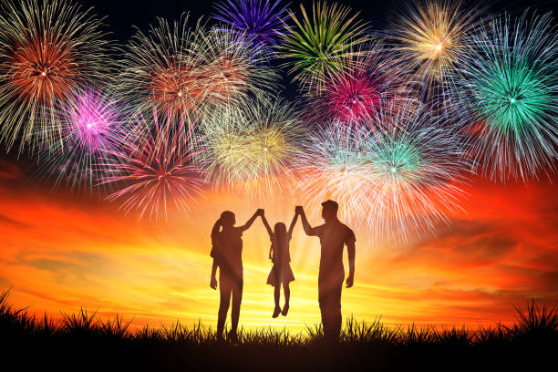 istock happy family standing and watching the fireworks 1158958720
