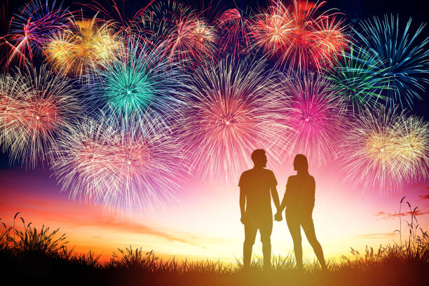 istock young couple watching fireworks on hill 1158958724