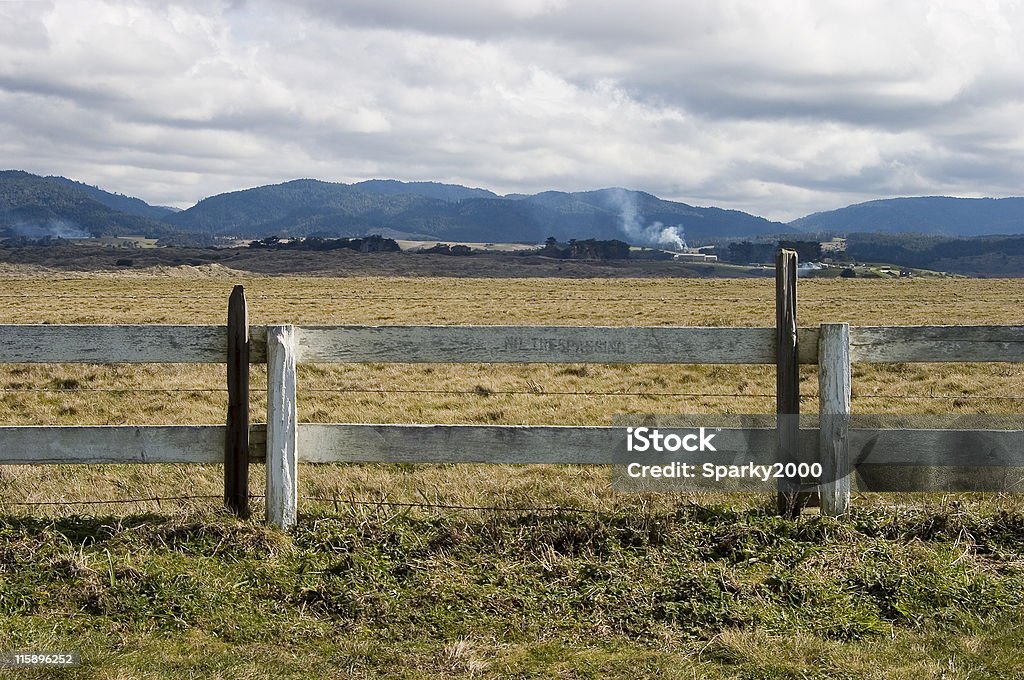 Scenic Fence A fence on the edge of an open field. Agricultural Field Stock Photo