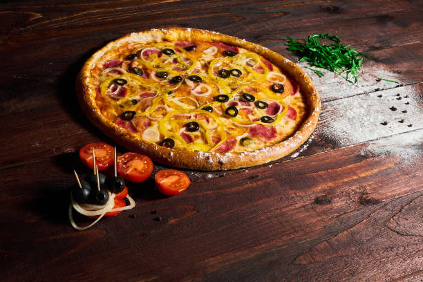 istock Delicious pizza with vegetables and cheese on a wooden table 1158963152