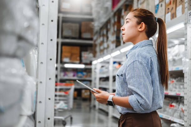 istock Asian woman worker working with digital tablet checking boxes Logistic import and export supplies packages in Warehouse , Logistics concept 1158964133