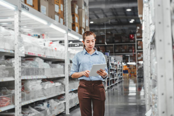 istock Asian woman worker working with digital tablet checking boxes Logistic import and export supplies packages in Warehouse , Logistics concept 1158964136