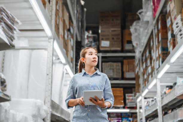 istock Asian woman worker working with digital tablet checking boxes Logistic import and export supplies packages in Warehouse , Logistics concept 1158964142