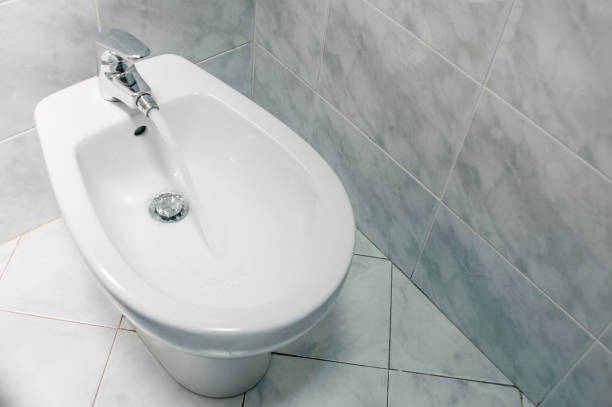 istock Bidet with running water top down, with copy space. 1158965959