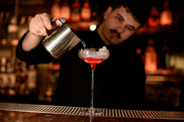 istock Bartender pours cocktail from a steel mug 1158970646