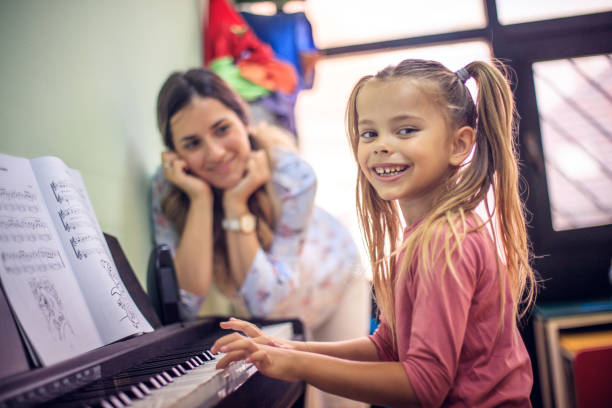 i love playing the piano. - practicing piano child playing imagens e fotografias de stock