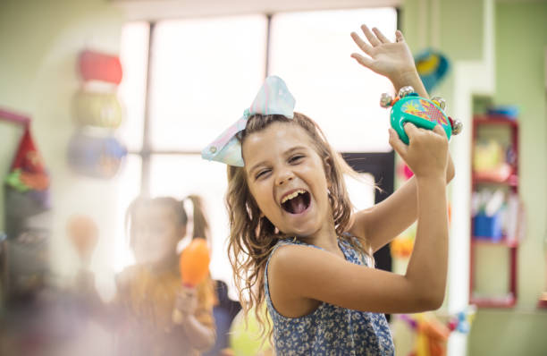 Dancing to their own tune. Dancing to their own tune. Child in music school. percussion instrument stock pictures, royalty-free photos & images