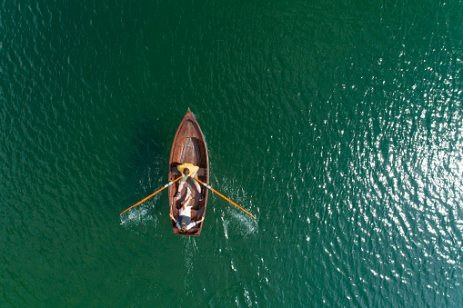 Young Couple In A Boat On The Background Of A Lake, Aerial View.