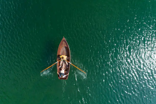 Photo of Young Couple In A Boat On The Background Of A Lake.