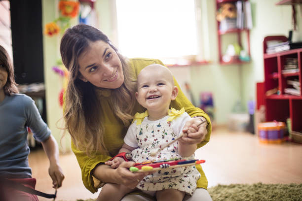 She love music so much. She love music so much. Baby in music school. preschool classroom jobs stock pictures, royalty-free photos & images