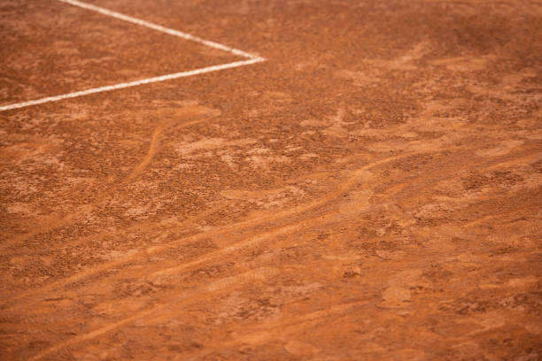 Bright greenish yellow tennis ball hitting the net