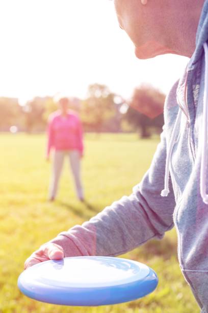 istock Cropped image of senior man playing with flying disc on sunny day 1158976933