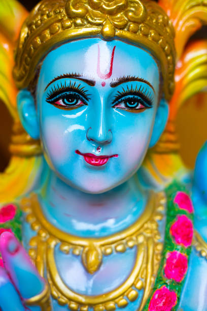Closeup Portrait of  Hindu God Krishna in colorful glossy  statue. Closeup Portrait of  Hindu God Krishna in colorful glossy  statue. Krishna janamsatmi concept. radha krishna stock pictures, royalty-free photos & images