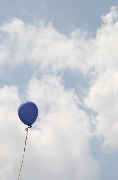istock blue balloon flies high in the sky 1158977968