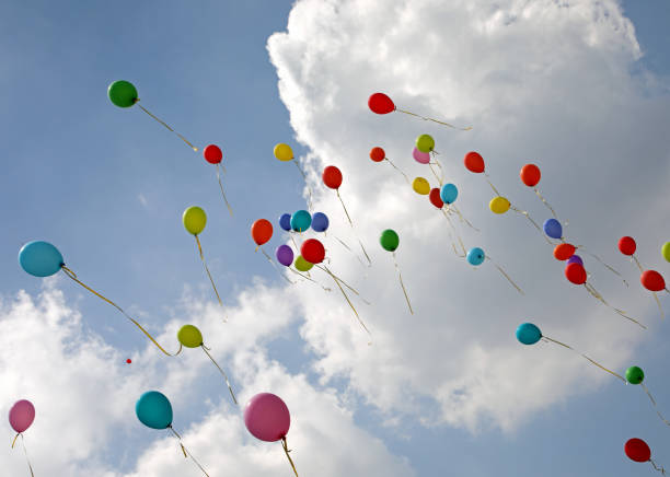 istock colorful balloons flying high in the blue sky 1158978005