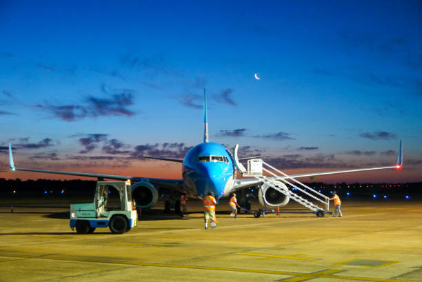 istock blue plane parking at the airport garage 1158978952