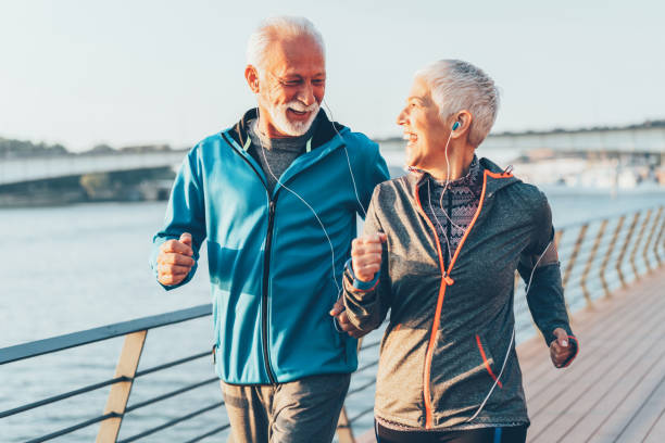 istock Senior couple jogging together 1158981969