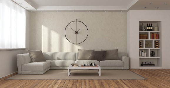 Minimalist living room with sofa, coffee table , bookcase and big clock on wall - 3d rendering
Note: the room does not exist in reality, Property model is not necessary
