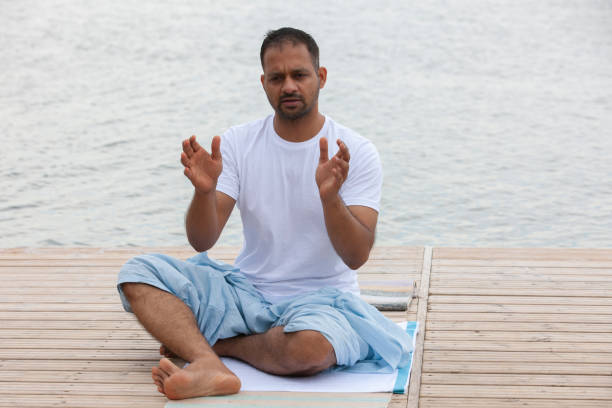 istock Man doing yoga exercise in the morning. 1158986673