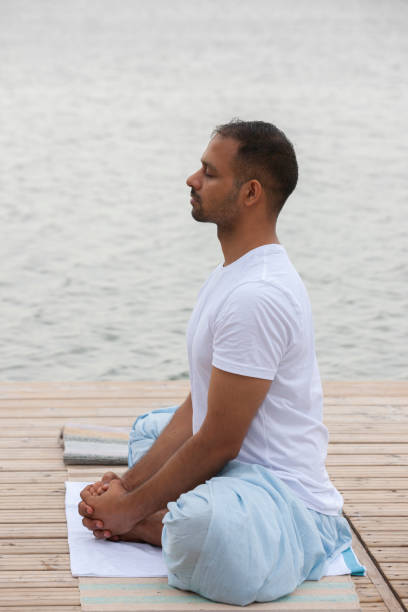istock Man doing yoga exercise in the morning. 1158987405