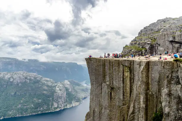 Photo of Panorama view from Preikestolen or Prekestolen. Pulpit Rock, famous attraction near Stavanger. Cloudy fjord Lysefjord, Norway
