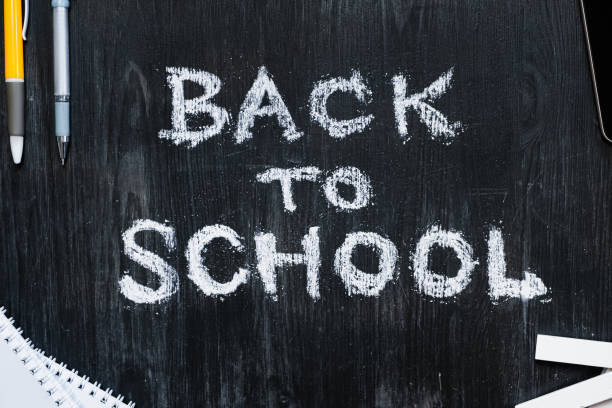 istock Back To School phrase written on a black wood background. 1159001355