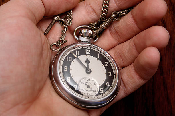 istock Hand holding antique pocket watch and chain 115900318