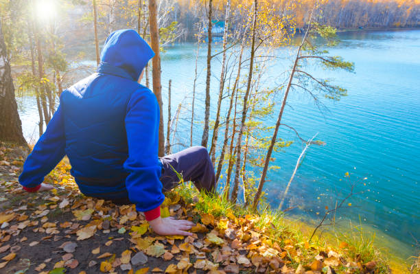 Lonely man looks at the lake