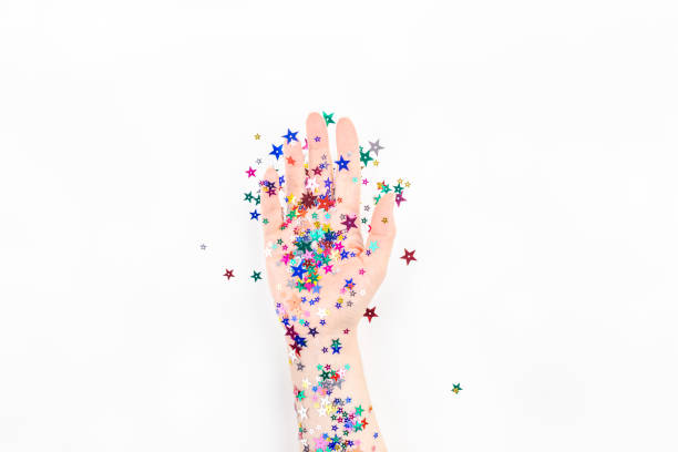 istock Woman hand with festive color star confetti 1159004939