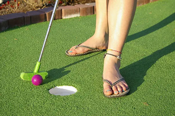 Photo of Woman golfing on mini golf course