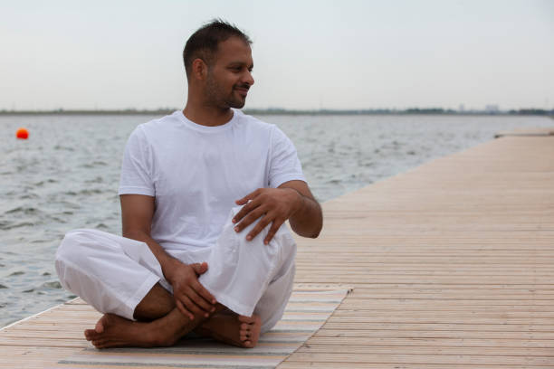 istock Young man doing yoga in morning park. 1159005399