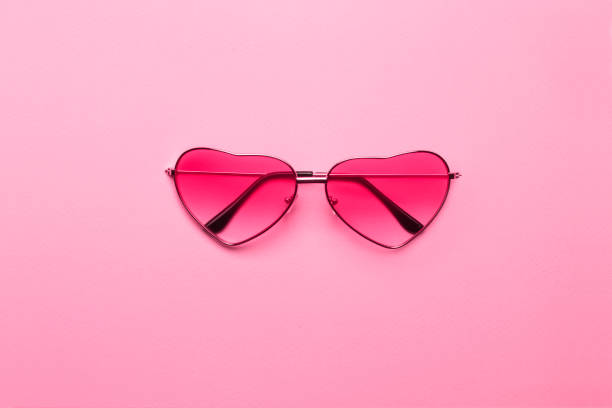 istock Heart-shaped glasses on a pink paper background. 1159009934
