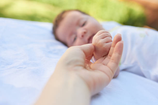 father hand touching his baby girl while sleeping. love and emotions.