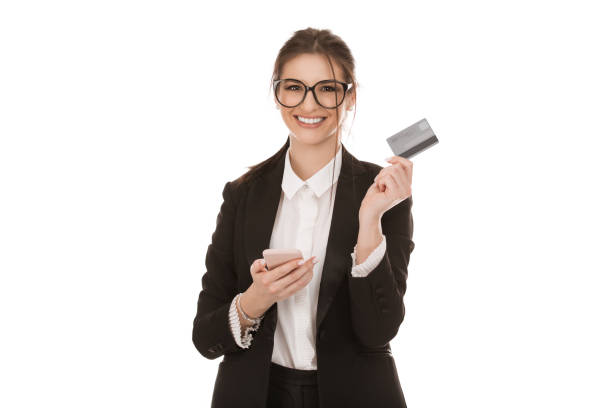 business woman holding mobile phone and a credit credit card smiling stock photo