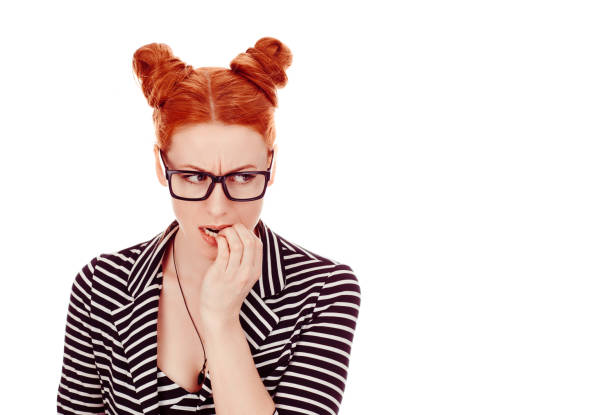 istock Hesitant woman biting fingernails craving for something or anxious 1159014770
