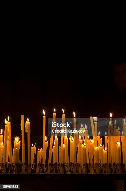 Tall Thin Candles Burning In The Dark Stock Photo - Download Image Now - Candle, Praying, Ceremony