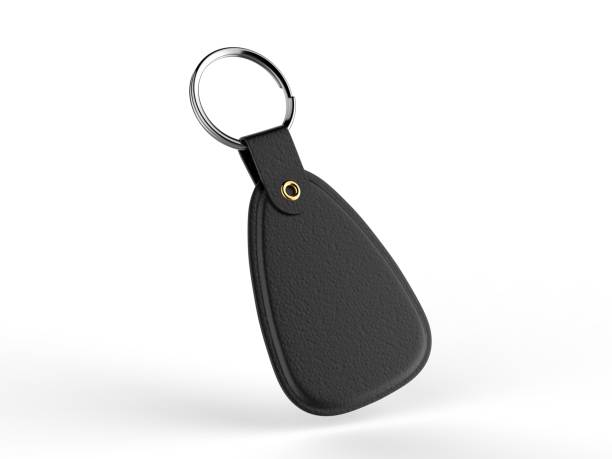 A blank, red key tag hangs against a vibrant yellow backdrop, ready for personalization.