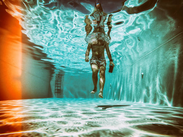 istock Social network addiction: man uses mobile phone underwater 1159016794