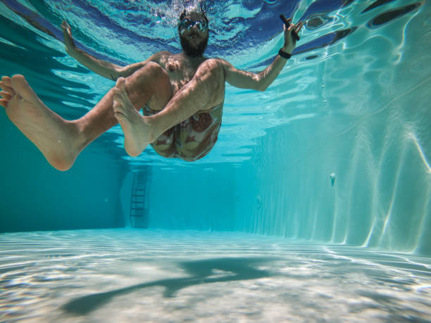 istock Man falls in a swimming pool with mobile phone 1159016831