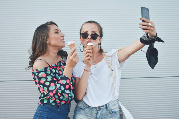 istock Beautiful women eating ice cream 1159016925