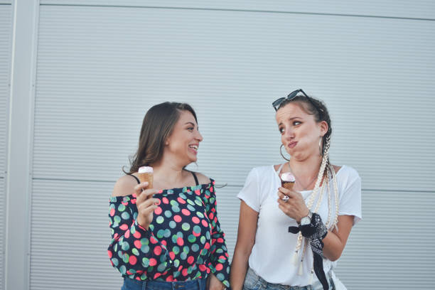 istock Beautiful women eating ice cream 1159016935